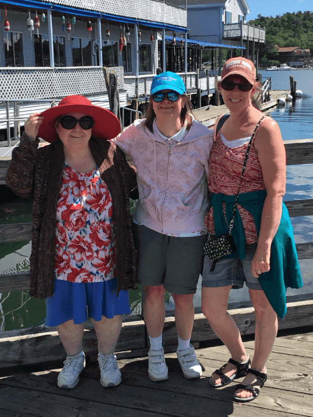 Jean, Marcia and Jane wearing sunglasses and standing on a dock