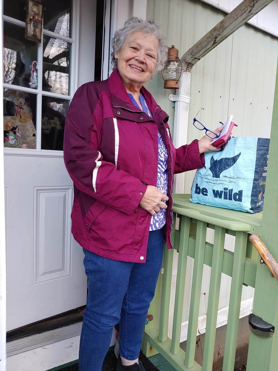 Homeowner Nila Patterson, standing by her new shelf where she can place her belongings while unlocking her door.