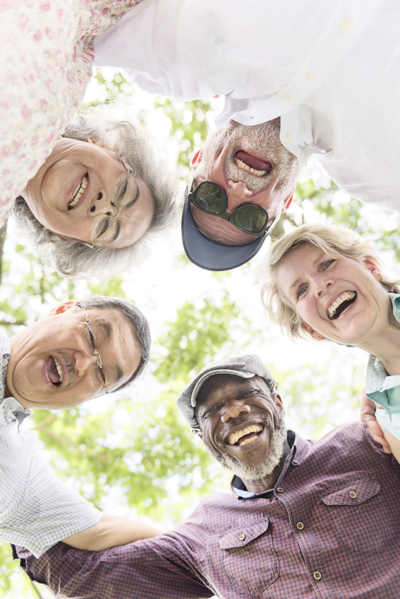 smiling elders looking down at camera in circle