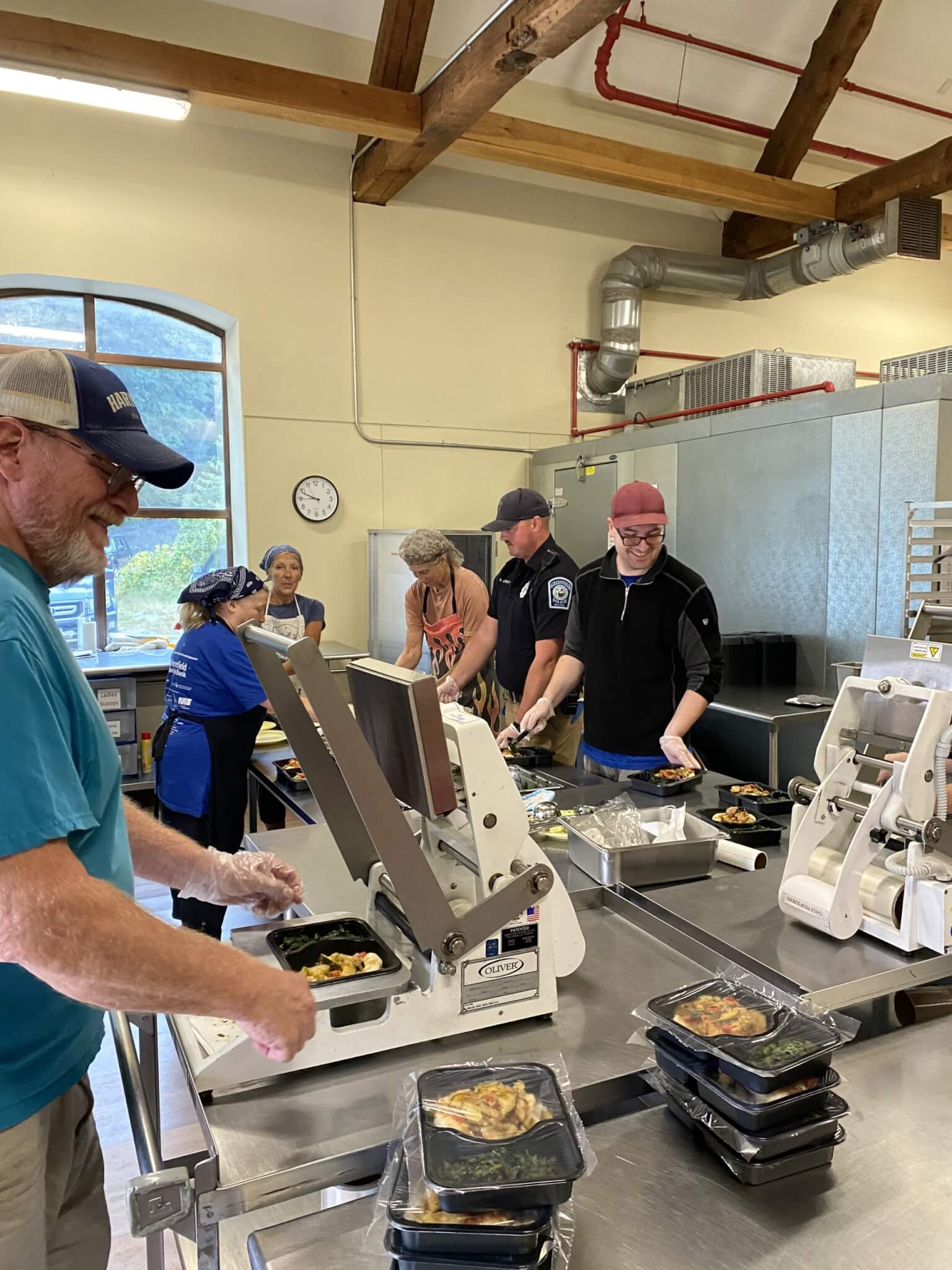 Officer Llewellyn and kitchen staff prepare meals in the kitchen.