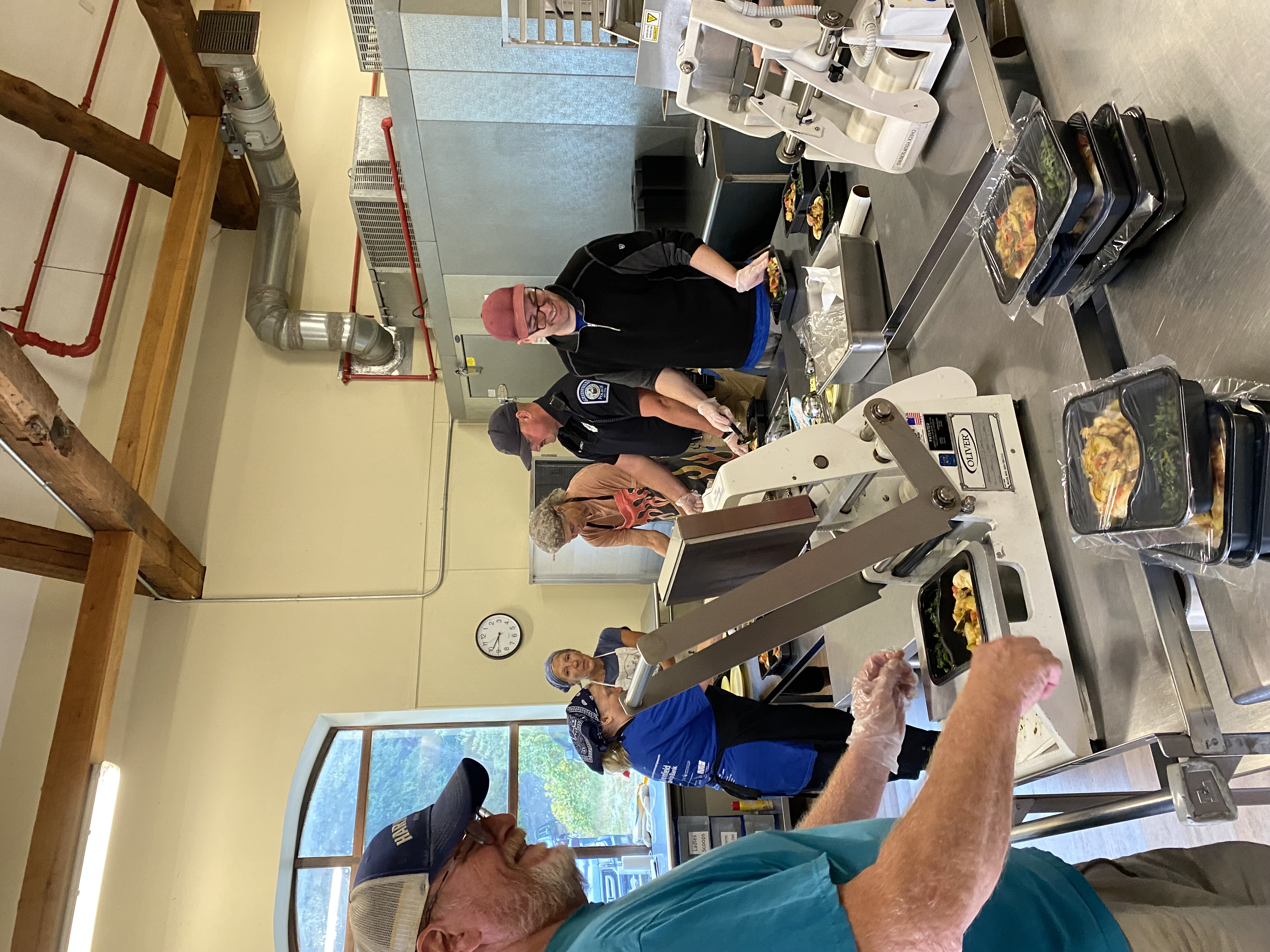 Officer Llewellyn and kitchen staff prepare meals in the kitchen.