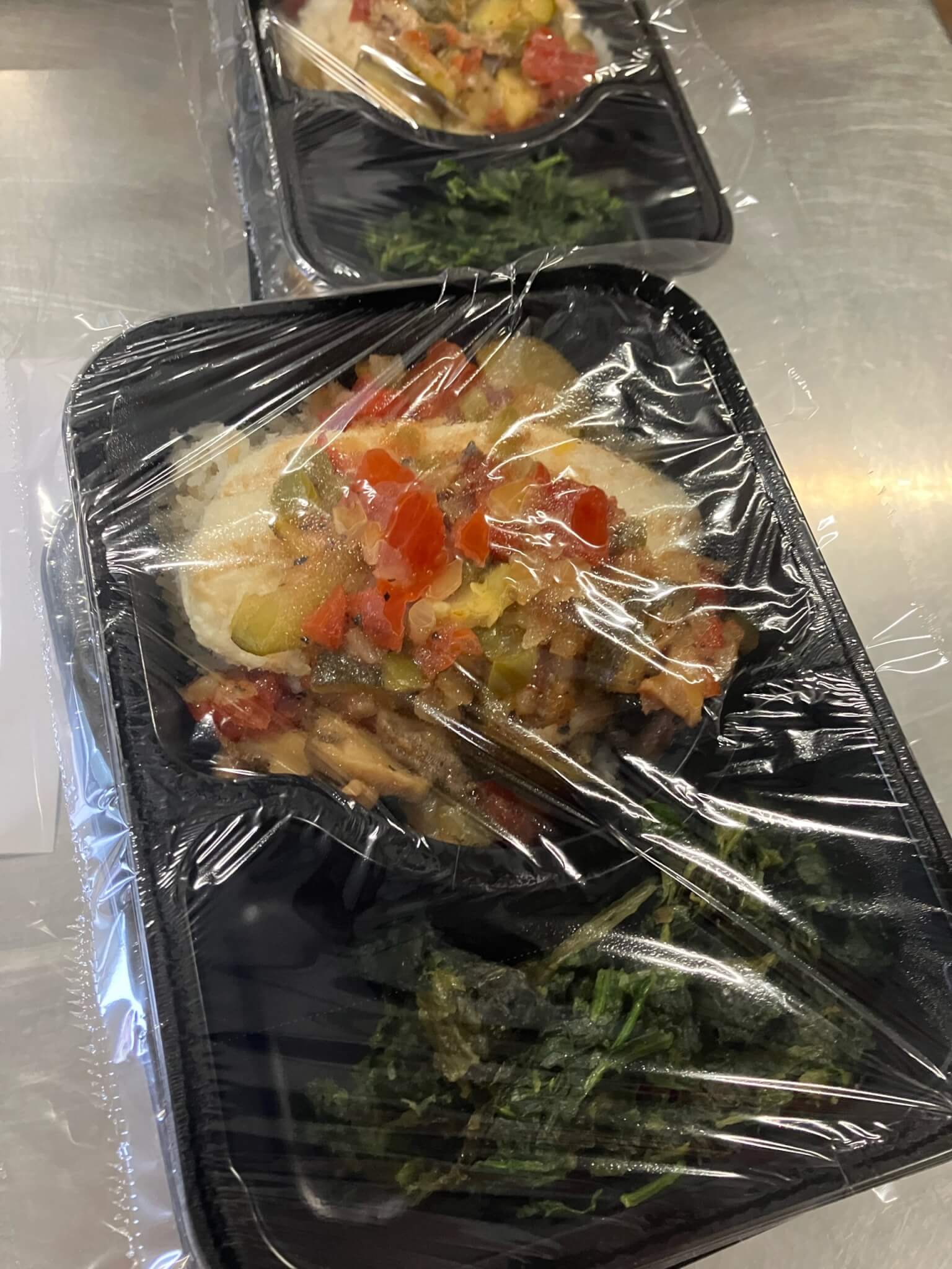 Chicken with sauteed vegetables, jasmine coconut rice, spinach, wheat bread, and fresh fruit.