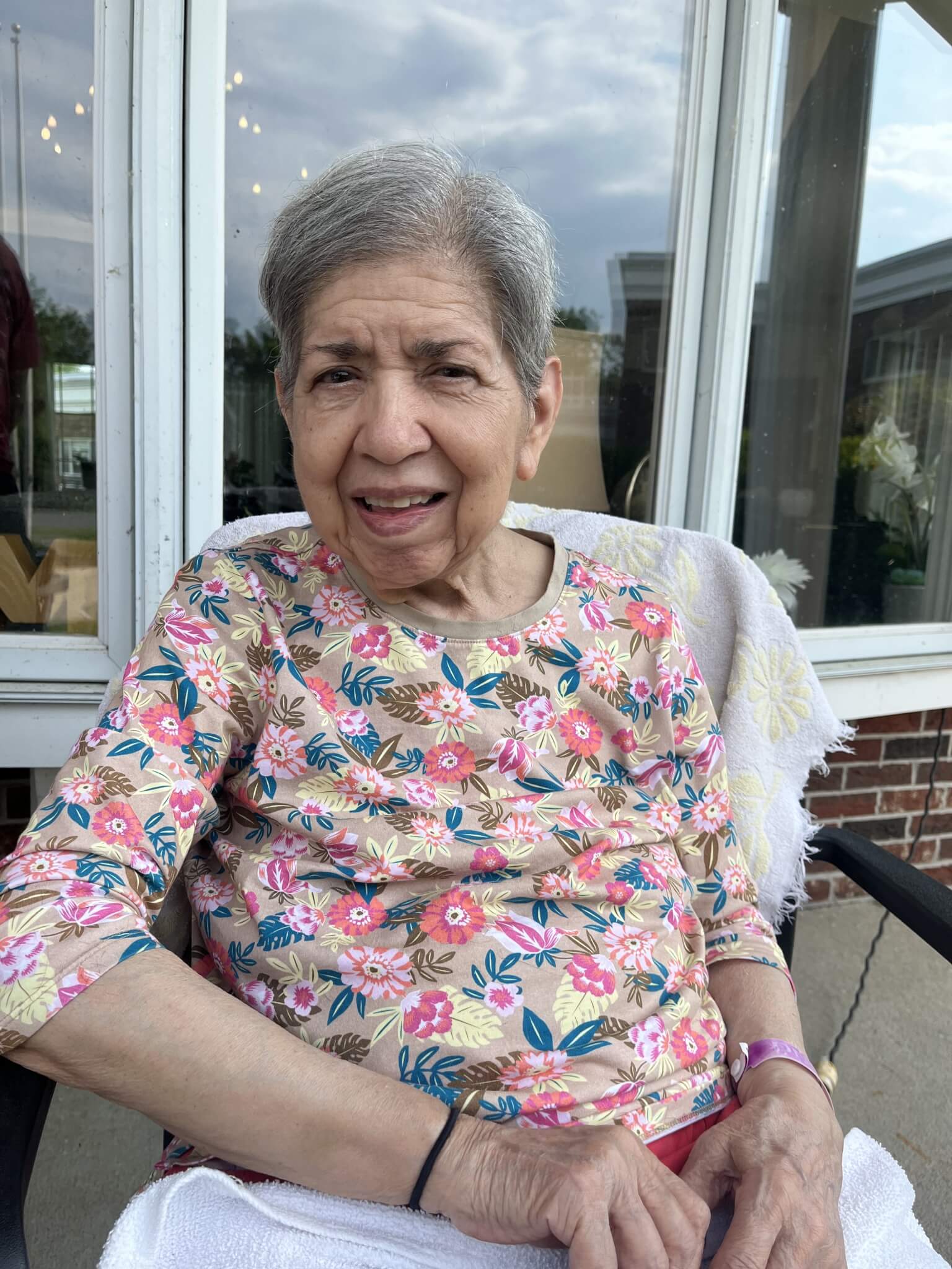 Aminta sitting outside and smiling.