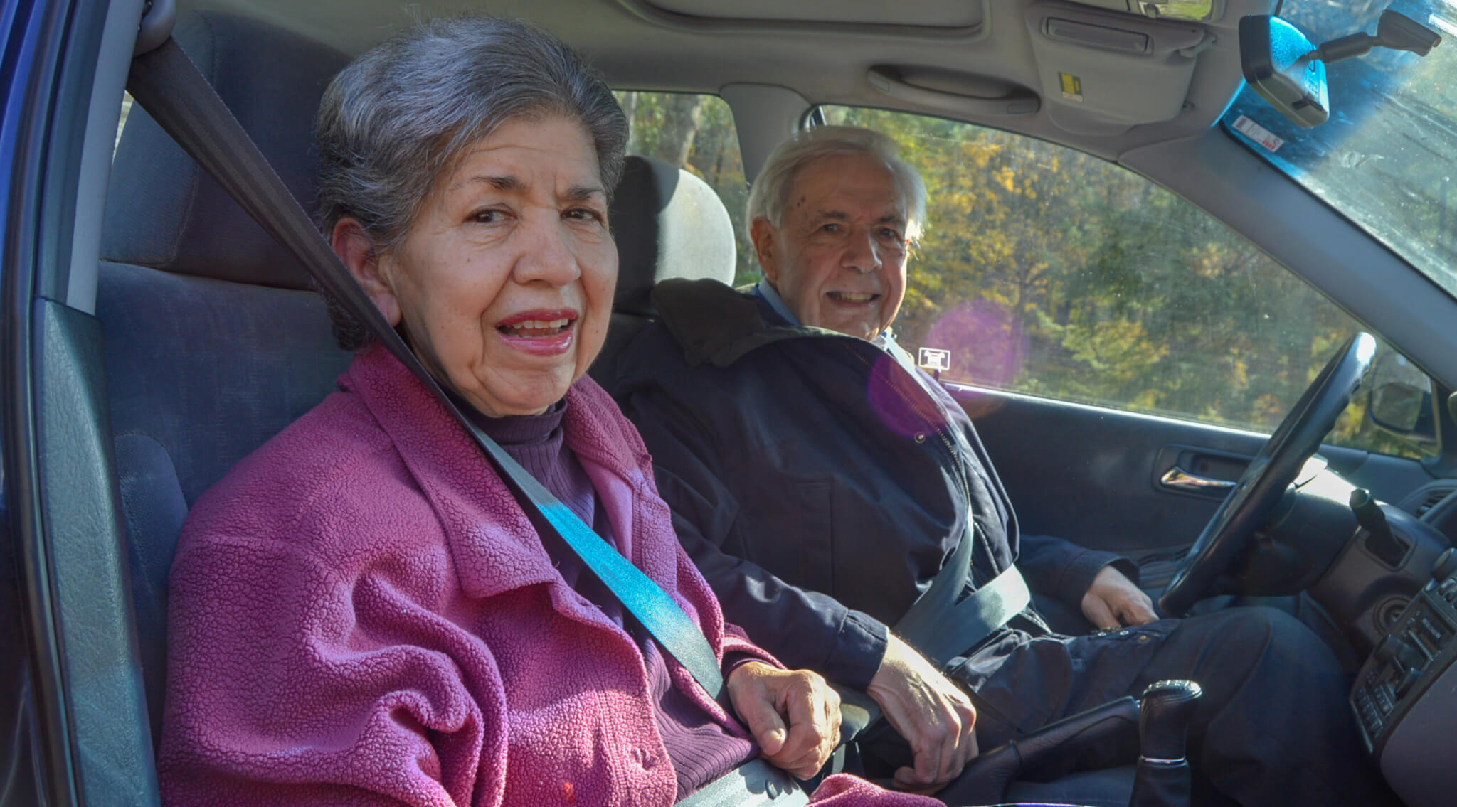 Aminta with John in his car on the way to a medical appointment