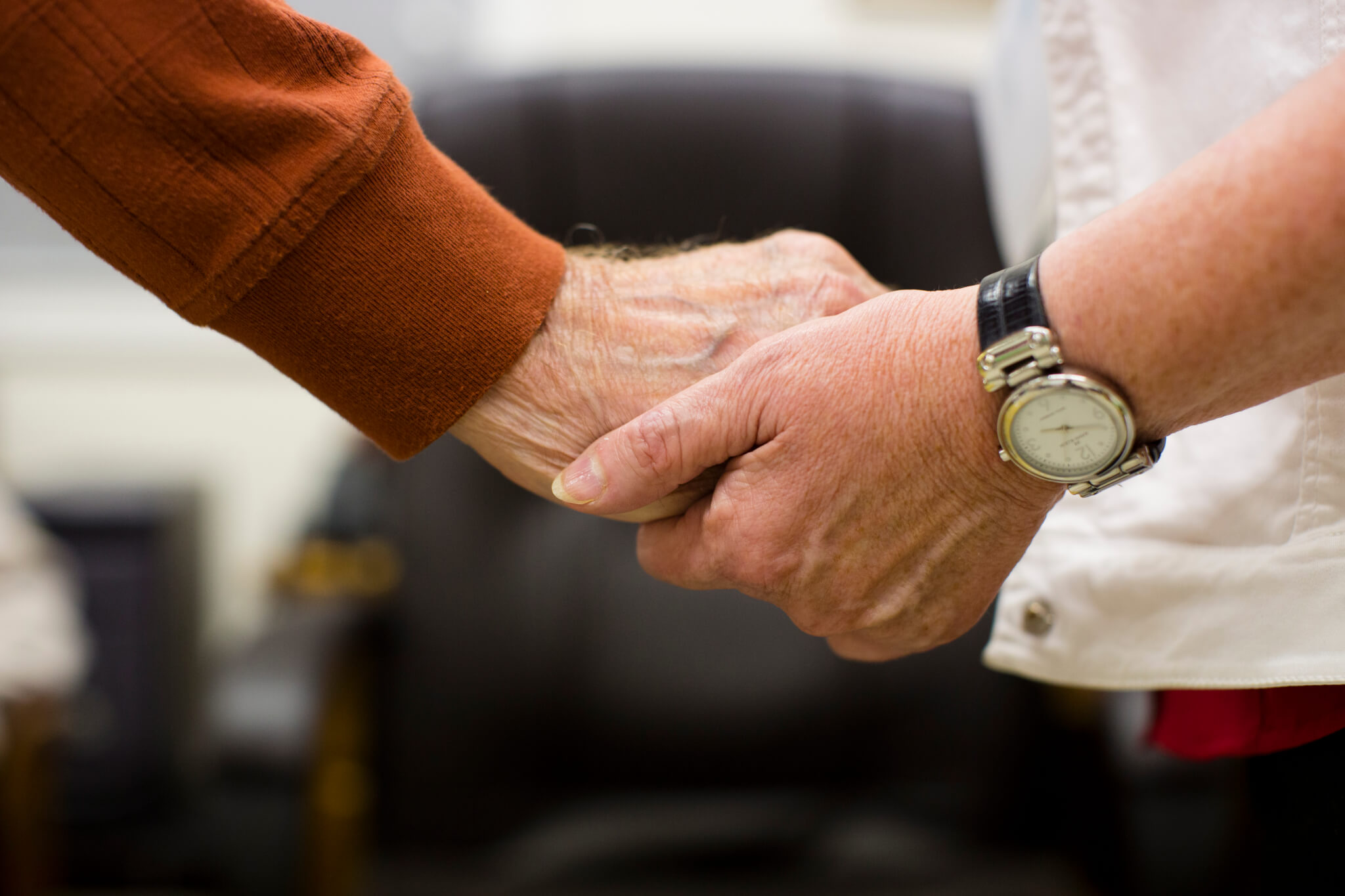 close-up of two people holding hands