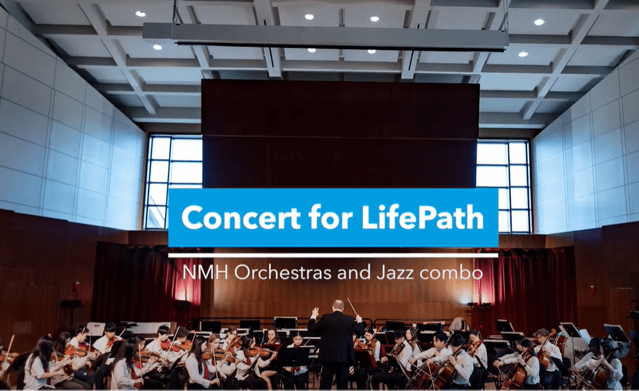 concert band playiing with "Concert for LifePath" banner