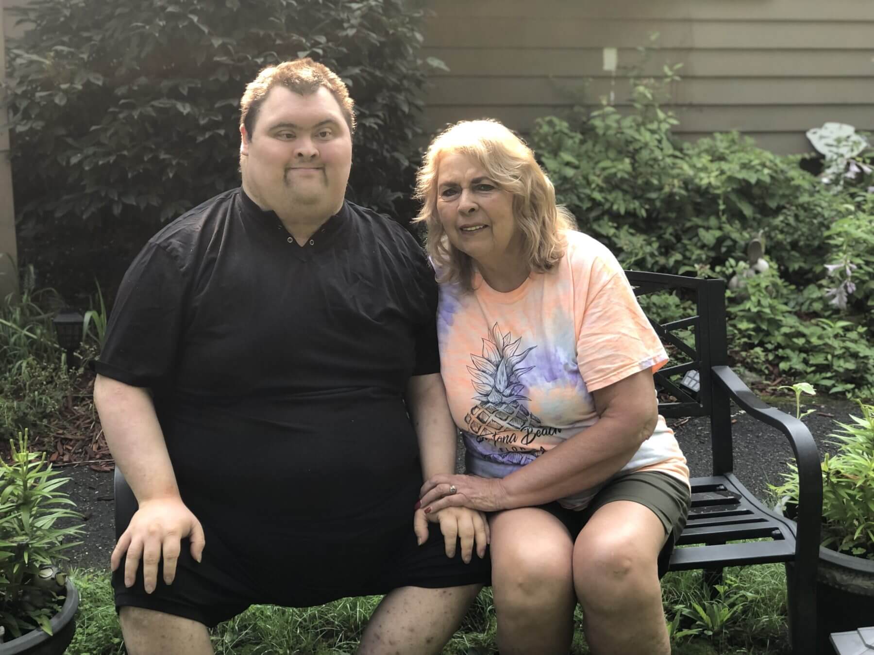 Nathaniel and Donna Marshall, sitting on a bench outside.