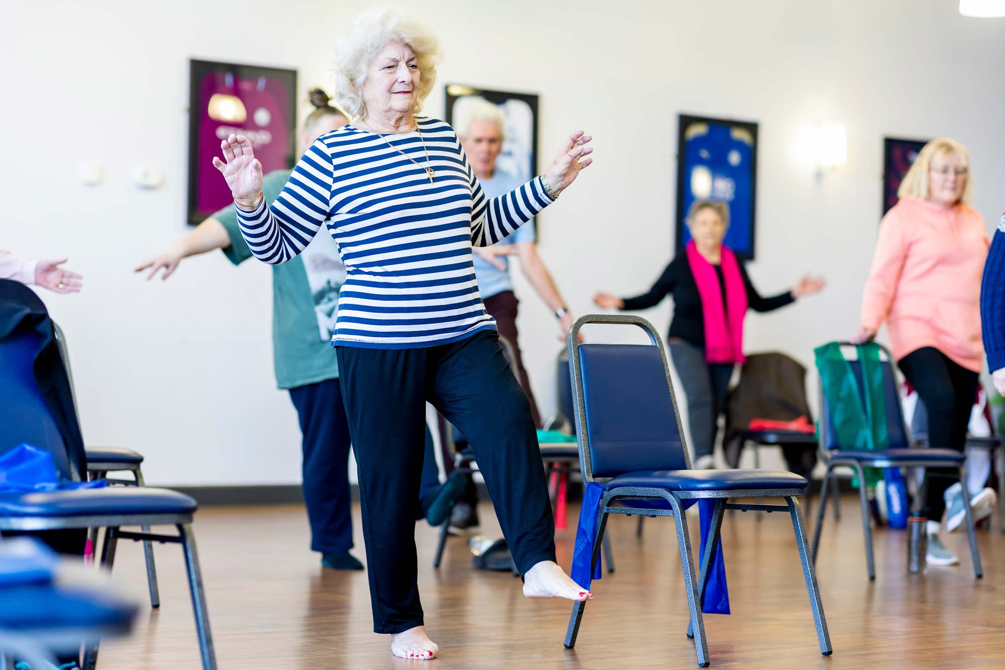 Older adults practicing balancing on one leg
