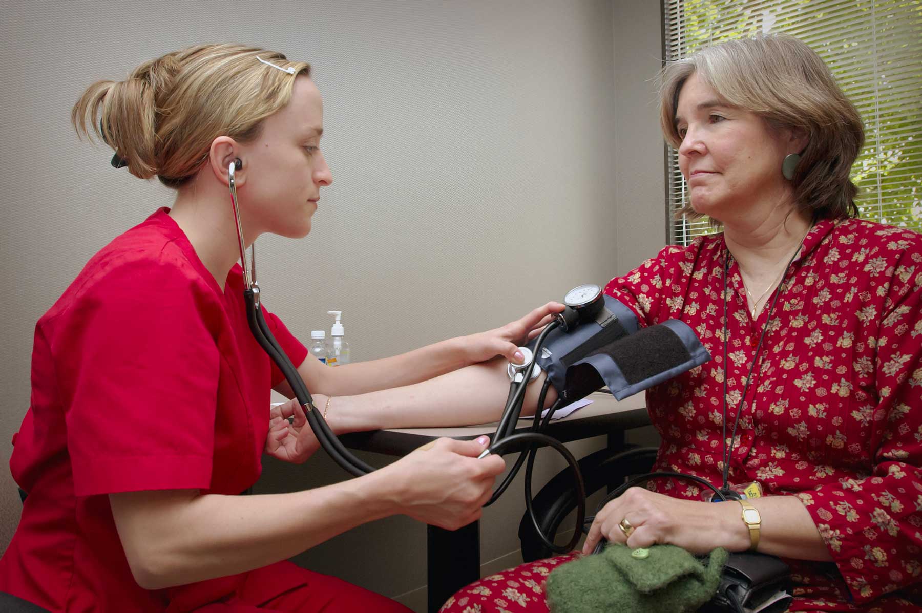 A nurse takes a patient's blood pressure
