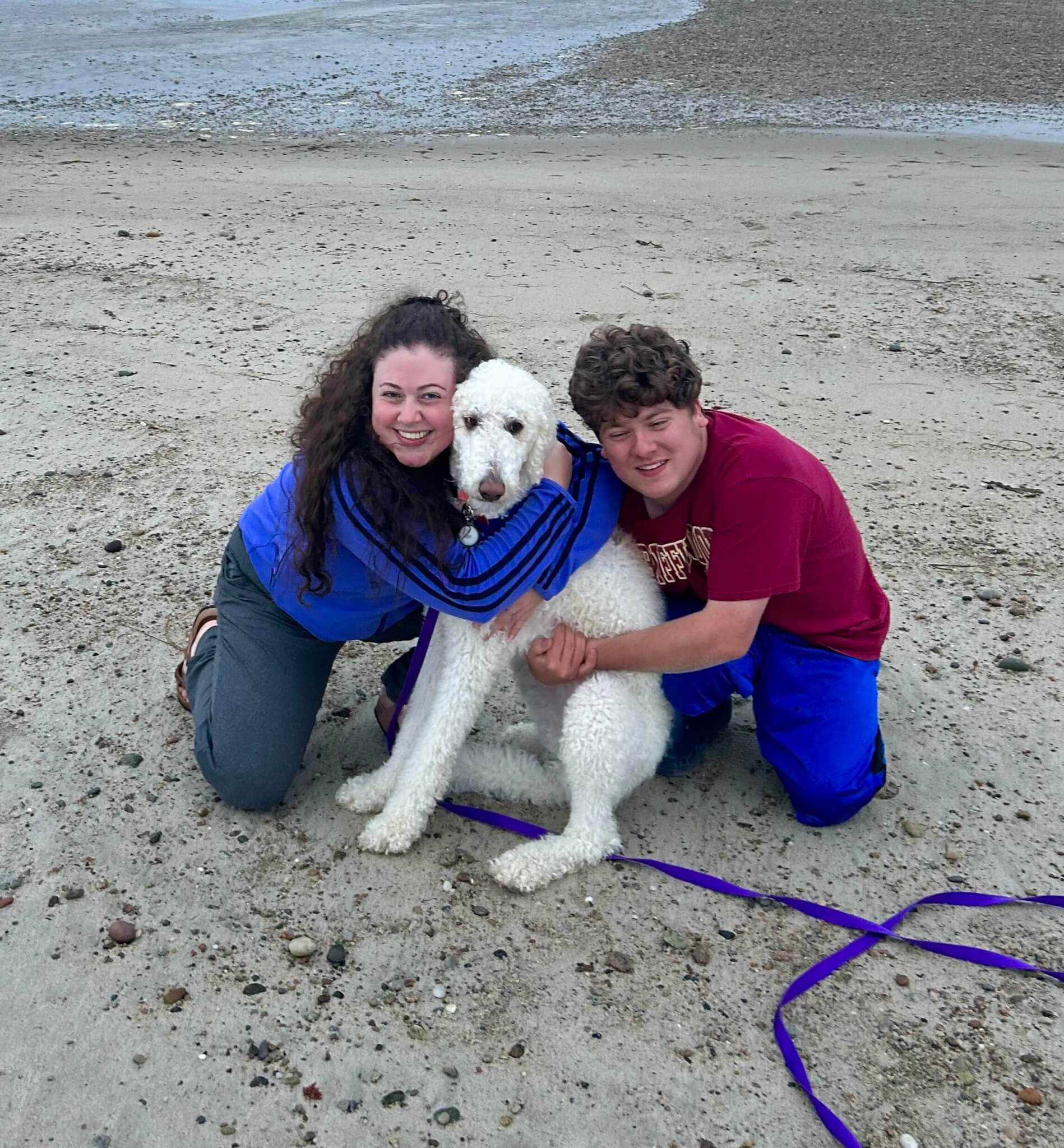 Maia and Max, with their new pup Momo, on the beach in Falmouth.