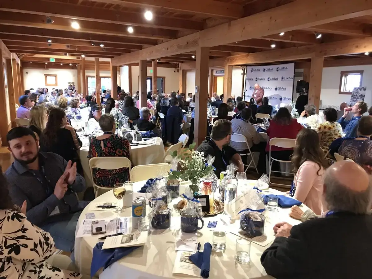 140+ people gathered at the banquet listening to the Executive Director speak