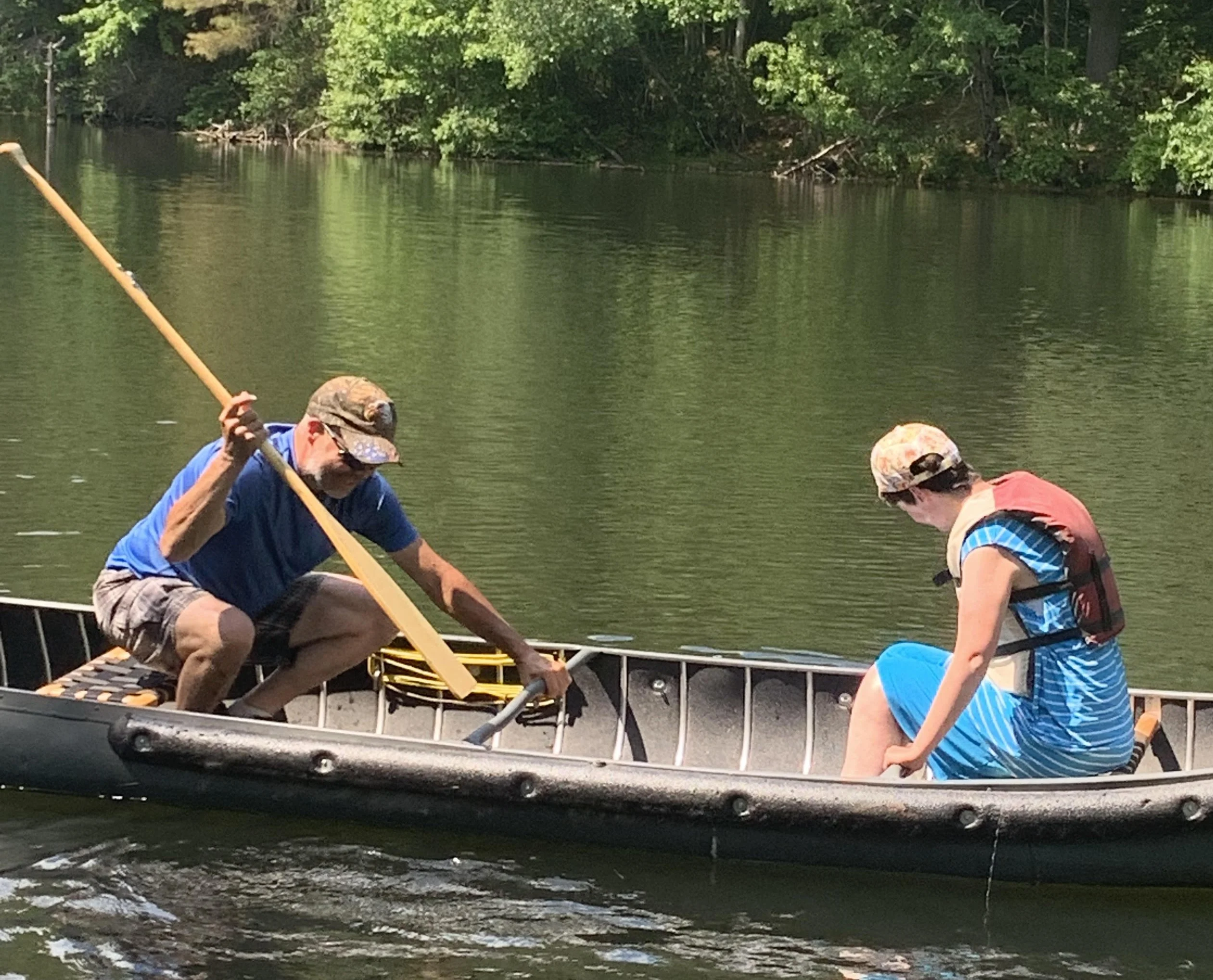 woman and man in row boat on river