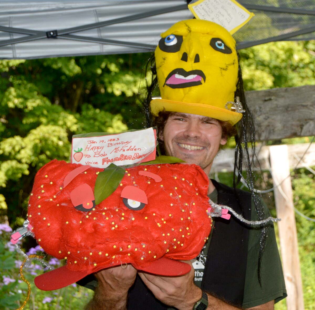 Patrick Gardner, holding his Franken Berry hat dedicated to the voice actor Bob McFadden, while wearing his Frankenstein hat, with a dedication to the author Mary Shelley.
