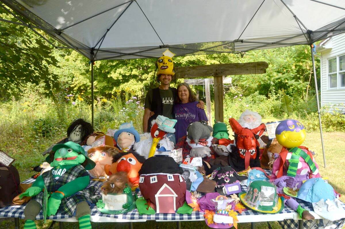 Patrick, with his mom, Mary, and just a fraction of the hats he’s made.