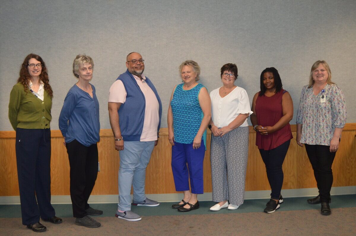 picture of Shine graduates facing each other in line, flanked by Lynne Feldman and Lorraine York-Edberg