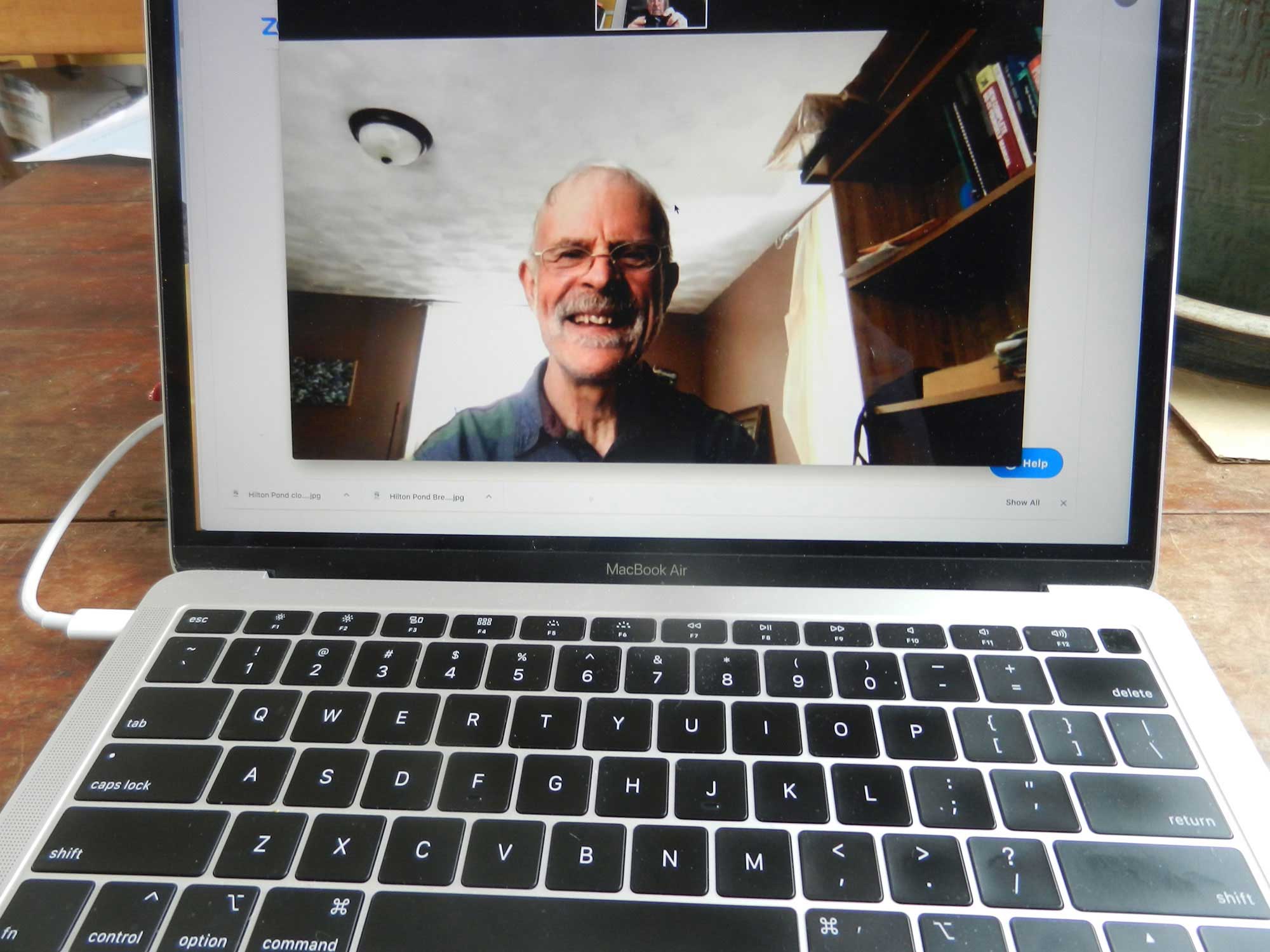 Dave Gott, Rainbow Elders Group Facilitator, smiling from a computer screen facing the camera