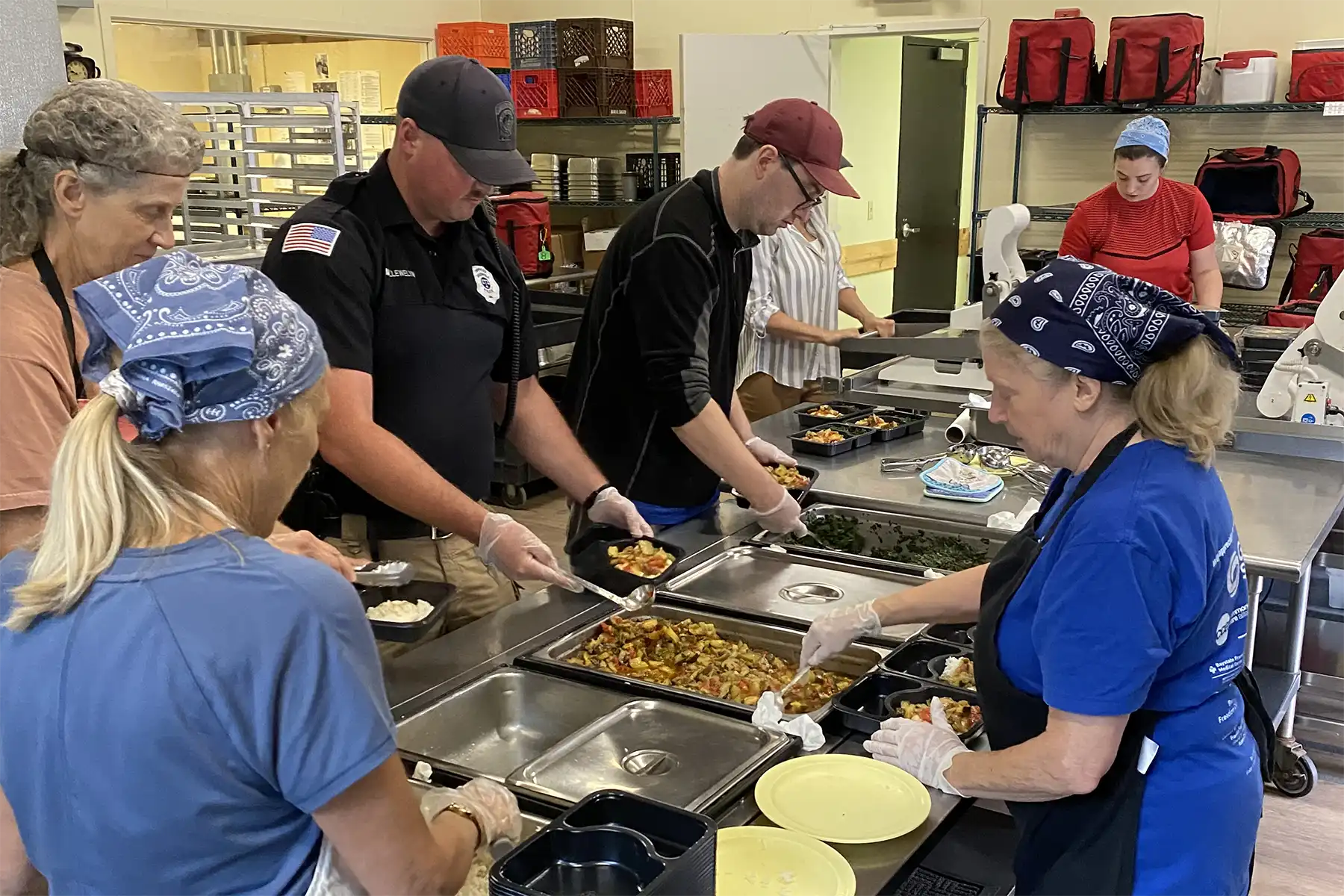 Meals on Wheels staff packing hot meals