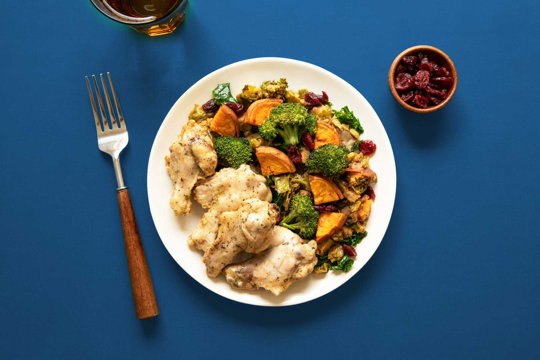 A plate of chicken with broccoli, sweet potatoes, and other vegetables. Photo by Ella Olsson on Unsplash.