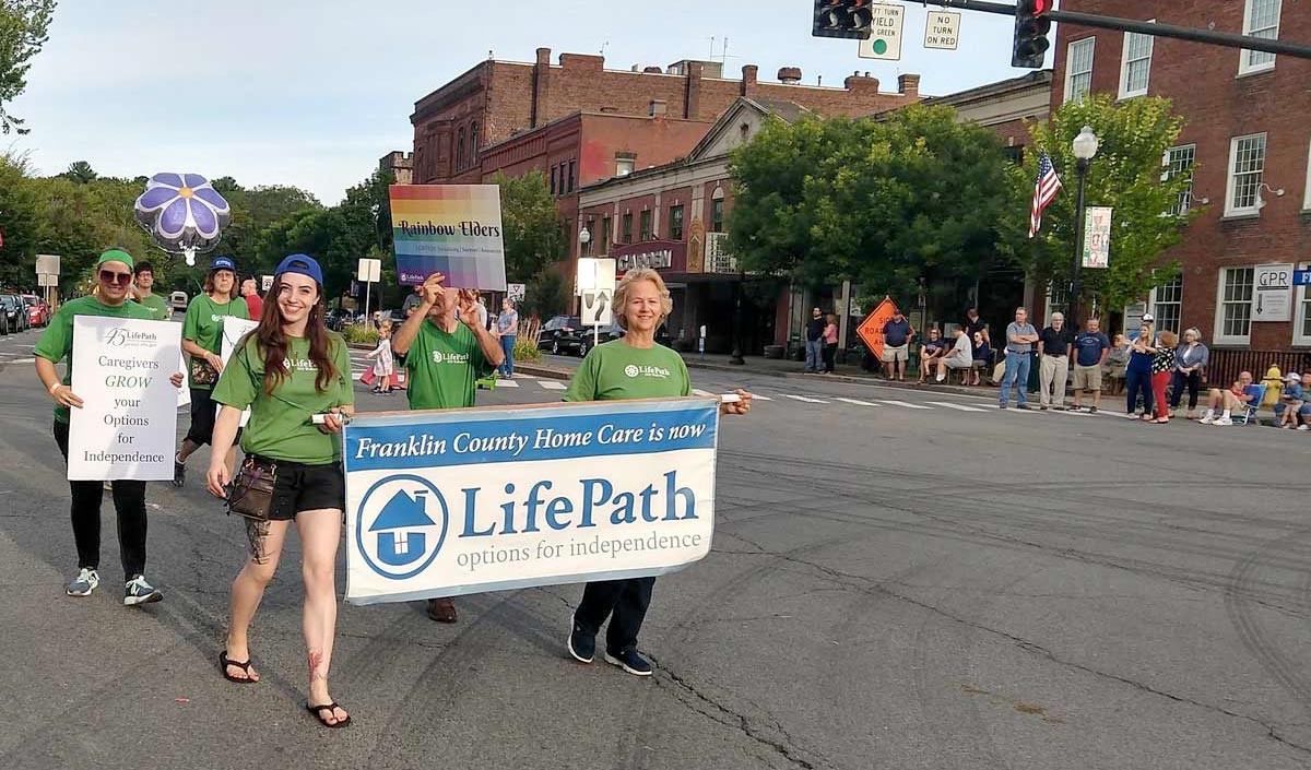 LifePath staff holding a banner and signs in parade